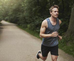 Man jogging down dirt road